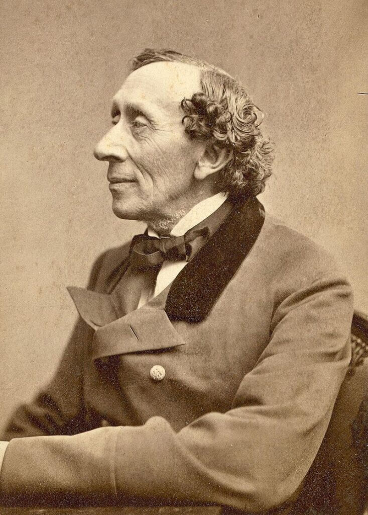 A sepia toned portrait of Hans Christian Andersen. Dressed in a buttoned jacket and gazing wistfully out of frame, his body is turned to the left.