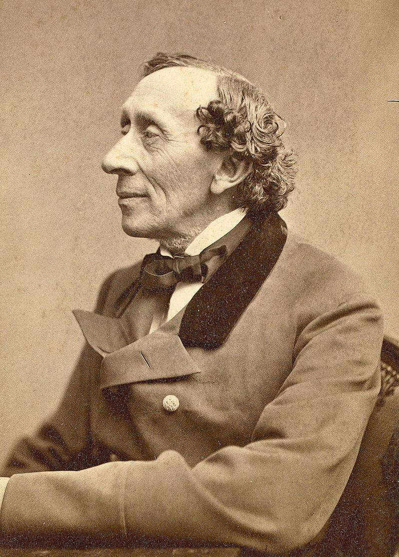 A sepia toned portrait of Hans Christian Andersen. Dressed in a buttoned jacket and gazing wistfully out of frame, his body is turned to the left. 