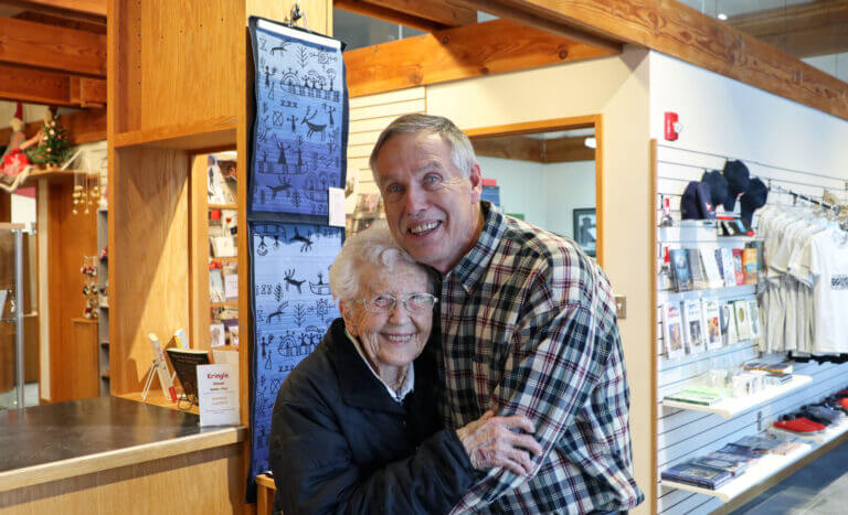 Rosa Clemsen and Tim Fredericksen hugging in front of the Design Store.