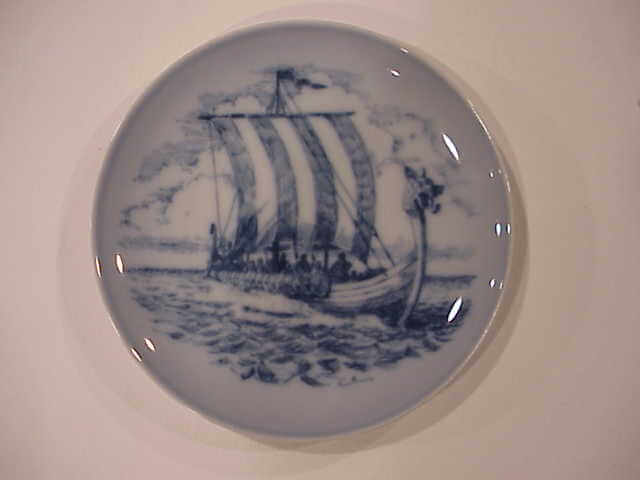 A blue and white plate depicting a Viking ship