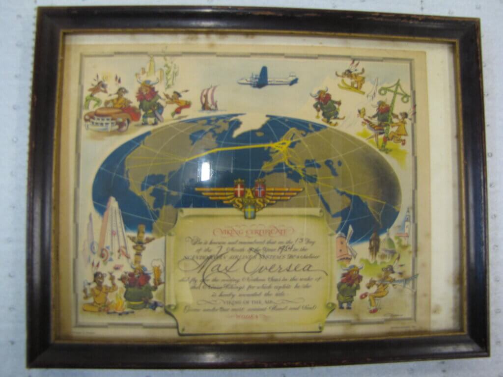 a print with a world map. Images of a Native American and a Viking surround the outside edge.