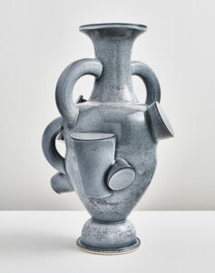 A blue gray vase with cup-like protrusions.
