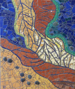 Mosaic with yellow and orange filling out the bottom and middle vertical portion of the mosaic, blue then encases it from the upper left and right corner.