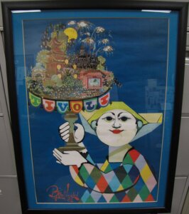 A framed poster. The poster features a white-faced clown holding an amusement park on a stand. Text on the poster reads "Tivoli." At the bottom is a signature reading "Bjorn Wiinblad. -81."