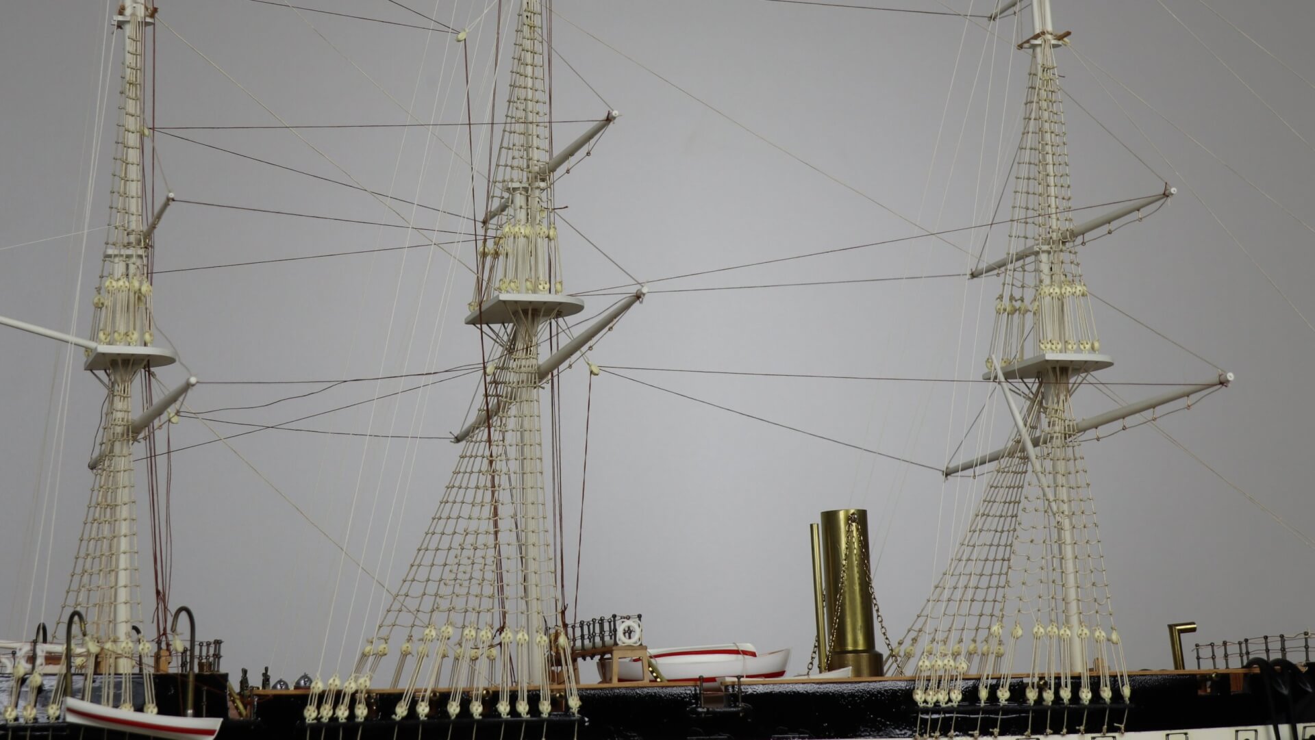 View of masts and rigging of a model ship.