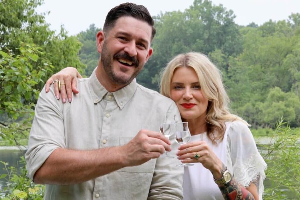 Robyn and Summer, founders of Norden Aquavit, bring together their glasses in a toast.