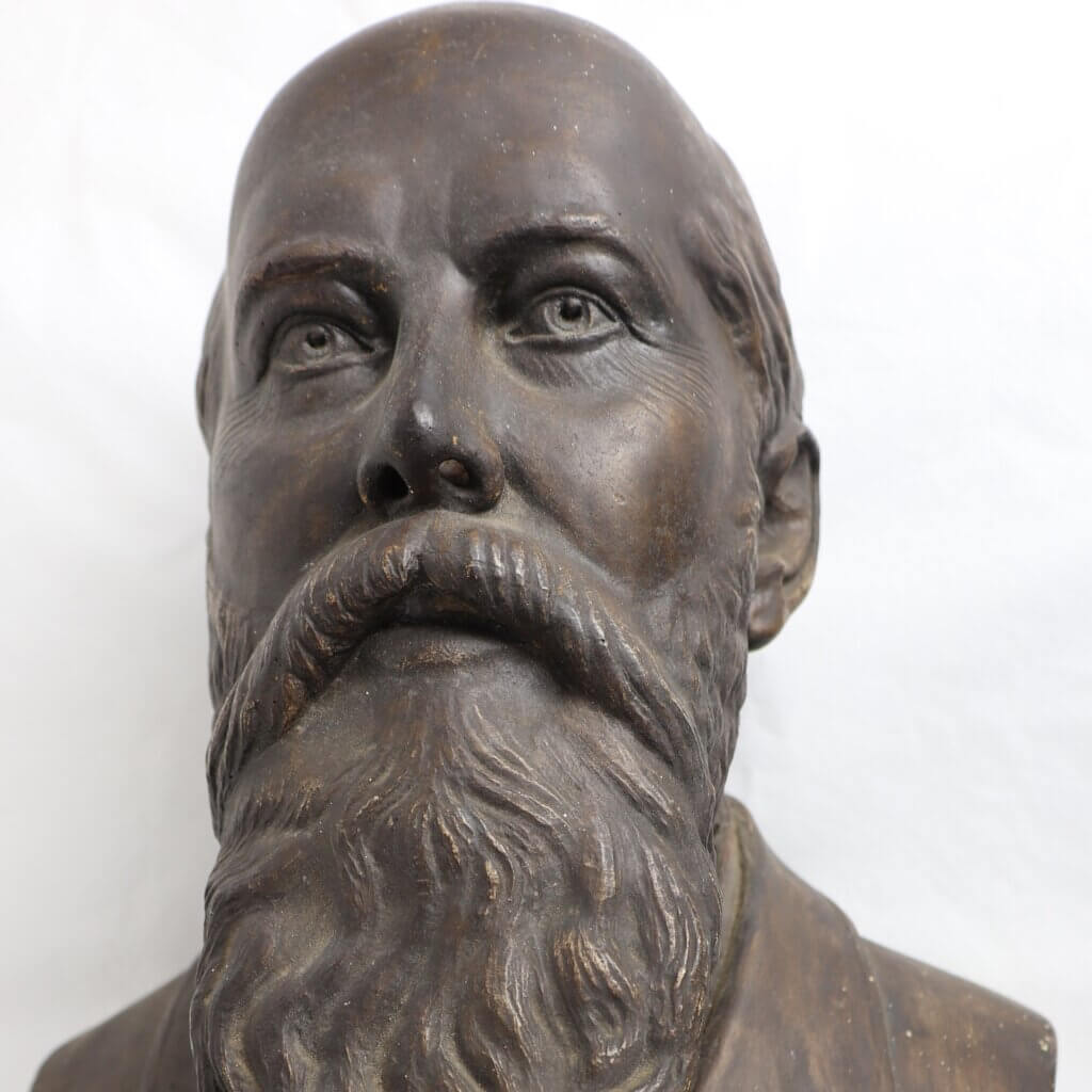 Bronze bust of a balding, bearded man, with detailed wrinkles.