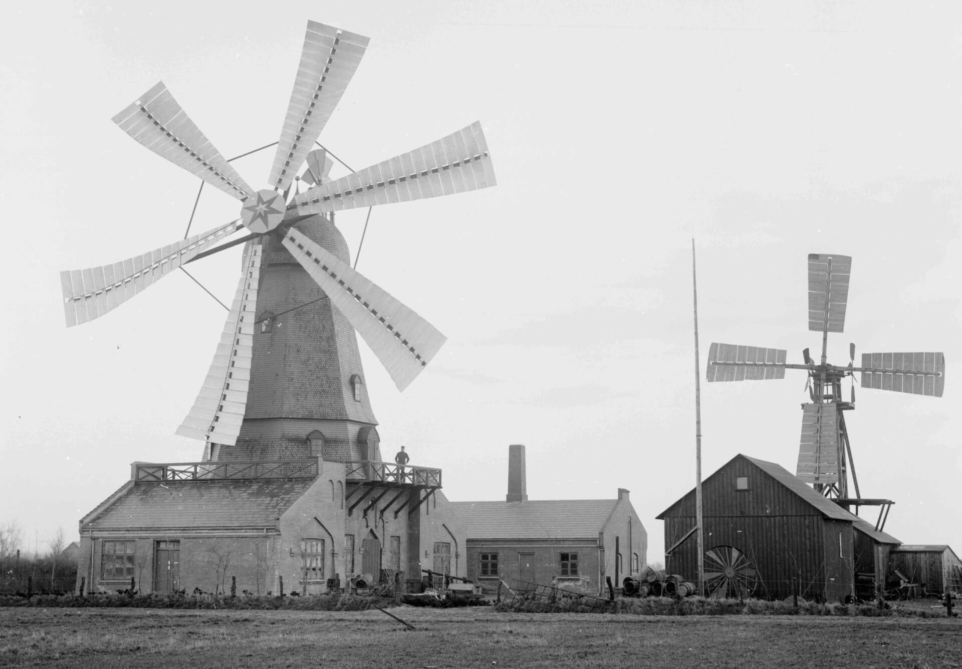 black and white photo of an old windmill with six sails