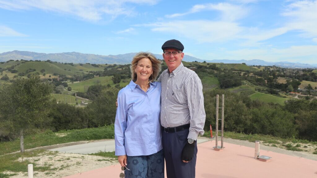Lynette and Kurt Rasmussen pictured before the mountains in Solvang, California.