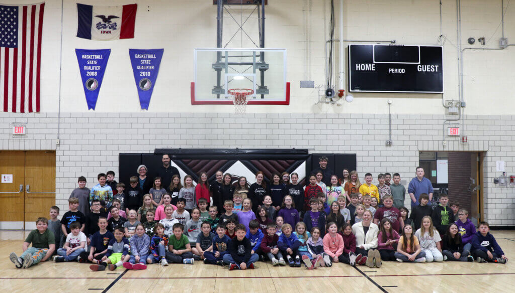 Museum of Danish America staff with Exira-Elk Horn-Kimballton elementary students in a gymnasium during outreach.